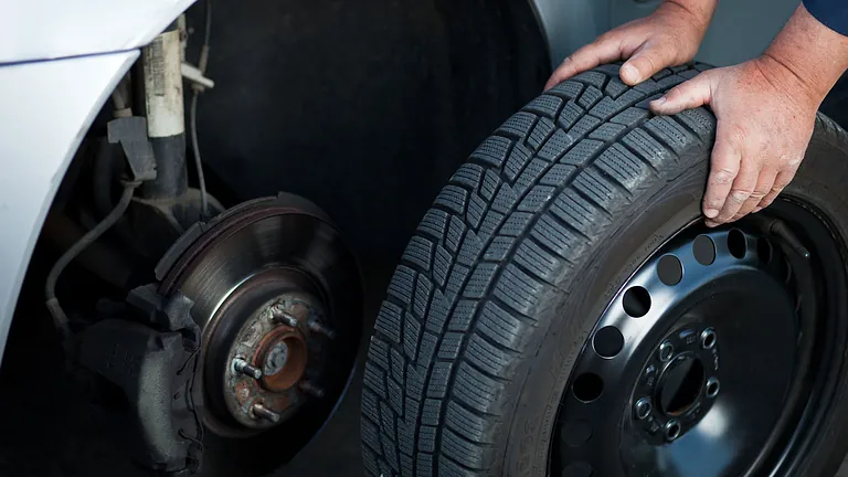 A wheel being replaced on a car