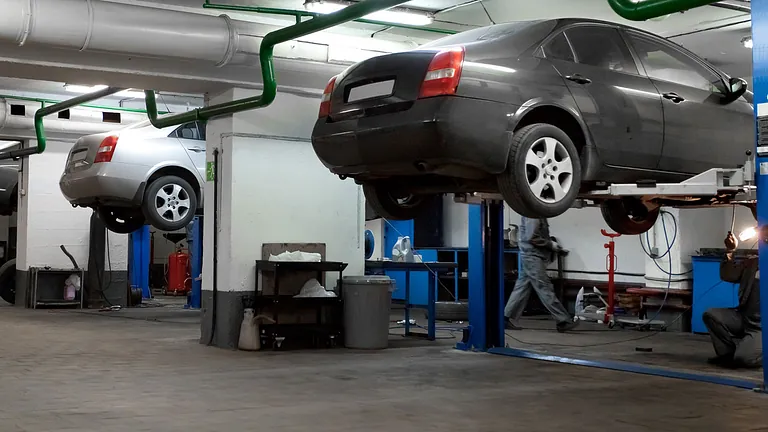 Cars in a garage getting a M.O.T. service
